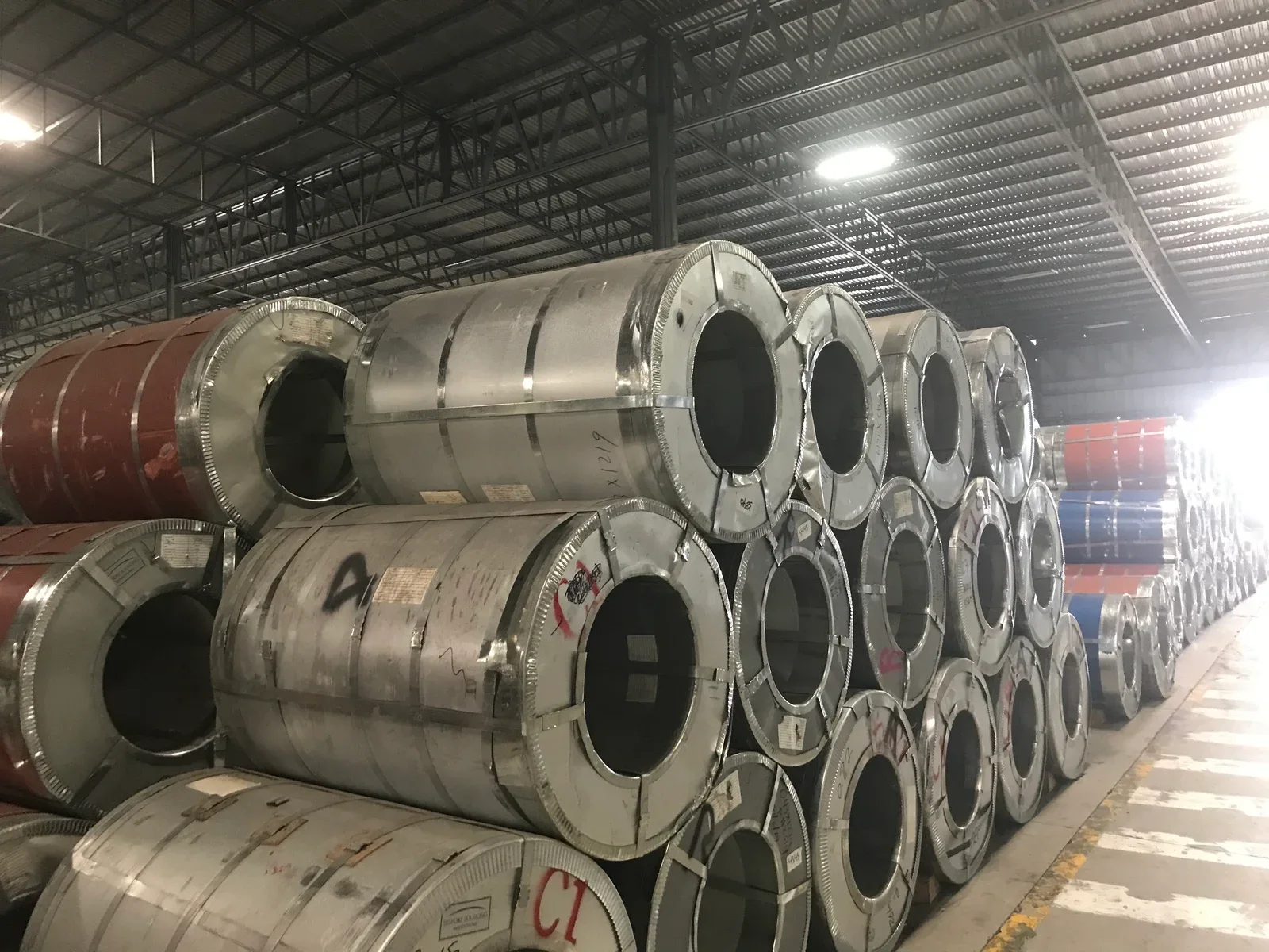 Packaged steel coil inventory in an industrial warehouse