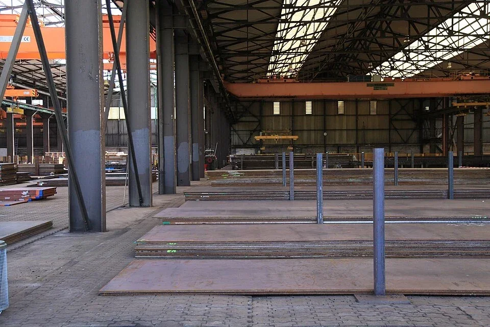 Stacks of flat steel plate in a warehouse